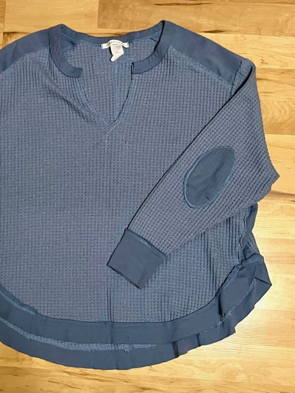 Cozy blue knit top with exposed-seam details & elbow patches!